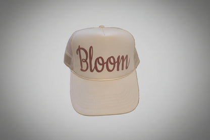 Beige cap with 'Bloom' text