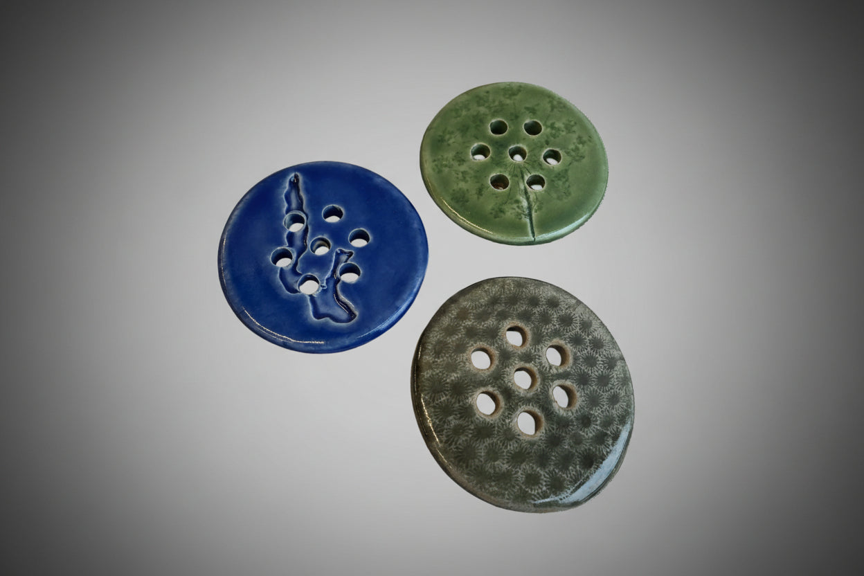 Flower Frog stem holders that sit on top the a mason jar. Three patters, one blue with an imprint of Walloon Lake, one green with an impression of a Queen Ann's Lace flower, and one gray faux Petoskey stone pattern